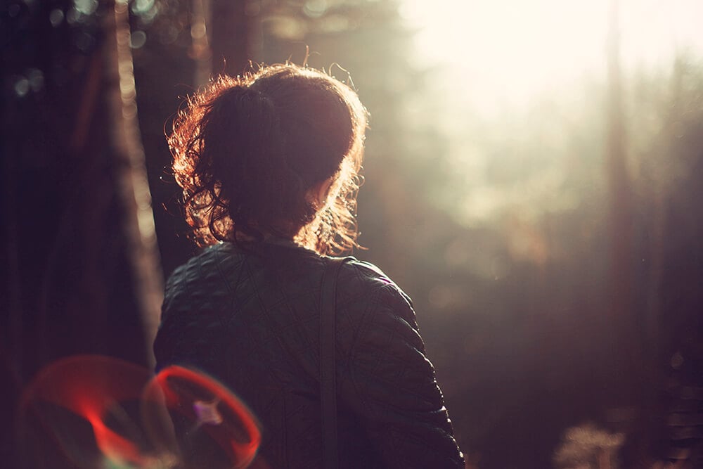 Peaceful woman sitting in forest